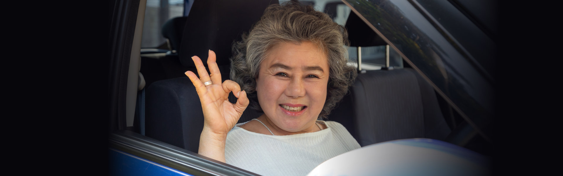 a woman with an okay hand gesture